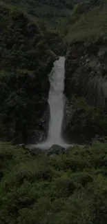 Lush green landscape with a tranquil waterfall cascading down rocks.