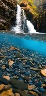 Serene waterfall with rocks and clear water, perfect for a mobile wallpaper.