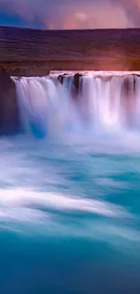 Serene turquoise waterfall flowing into a calm pool beneath a colorful sky.