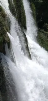 Serene waterfall cascading down surrounded by lush greenery.