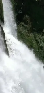 Serene waterfall cascading with lush greenery in background.