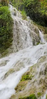 Serene waterfall cascading over lush green moss.