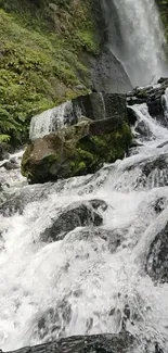 A serene waterfall with lush greenery and cascading waters, perfect for wallpaper.