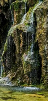 Serene waterfall wallpaper with mossy rocks and gentle water flow.