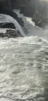 Majestic waterfall cascading between rocky cliffs.