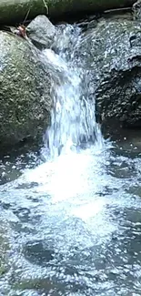 A serene waterfall cascades over rocks in nature.