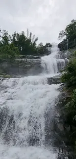 Serene waterfall with lush greenery and cascading water.