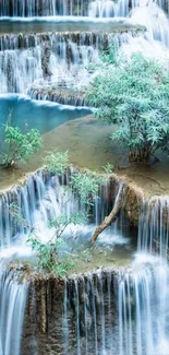 Cascading waterfall with lush green foliage.