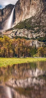 Majestic waterfall cascading down a mountain with serene reflections.