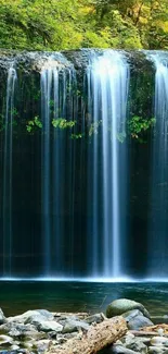 Waterfall with lush green forest background, perfect for mobile wallpaper.