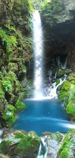 Serene waterfall amid lush green forest and blue water pool.