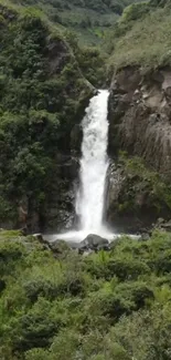 Waterfall cascading in lush green landscape wallpaper.