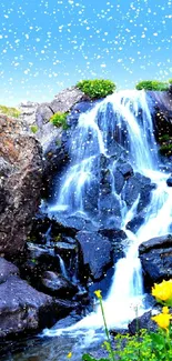 Beautiful waterfall with vibrant greenery and clear blue sky.