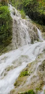 Serene waterfall cascading through lush green landscape.