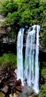 Waterfall with lush green trees in background, ideal for mobile wallpaper.