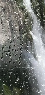 Wallpaper with raindrops and a waterfall on a window, creating a serene atmosphere.