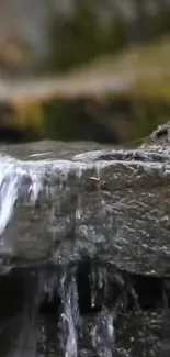 Serene waterfall over rocky surface in nature.