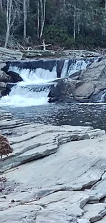 Serene waterfall with rocky landscape and calm waters.