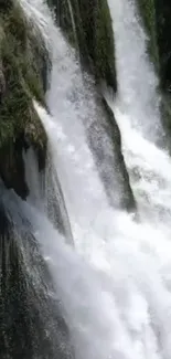 Serene mobile wallpaper of a cascading waterfall within lush greenery.