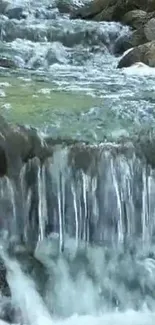 Cascading waterfall stream with lush greenery.