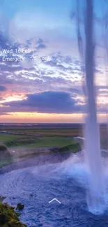 Waterfall at sunset with vibrant sky and serene landscape.