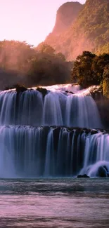 Serene waterfall at sunset with lush surroundings.