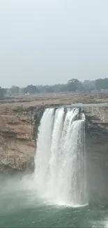 A serene waterfall cascading over rocky cliffs.