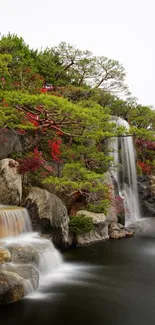 Tranquil waterfall and lush greenery mobile wallpaper.