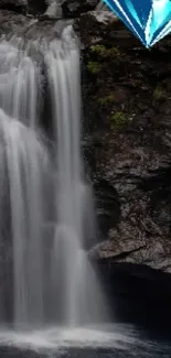 Waterfall with blue diamond on rocky cliff, perfect mobile wallpaper.