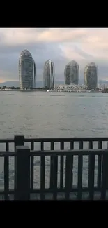 Serene skyline view from waterfront deck at dusk.