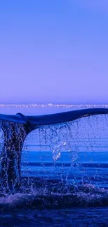 Whale tail emerging from blue ocean at sunset, creating a serene and tranquil scene.