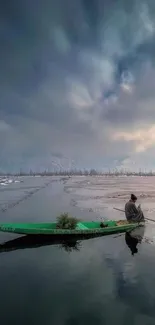 Lone figure in boat on tranquil winter lake, moody sky overhead.