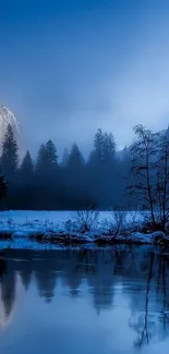 Snowy mountains with lake reflection under a blue sky.