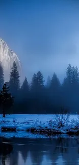 Serene mountain scenery with misty blue hues and calm waters.