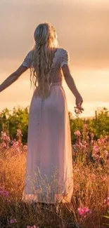 Woman in a white dress standing in a sunlit field, surrounded by flowers.