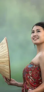 Woman with bamboo hat in misty nature setting.