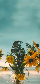 Yellow flowers in a jar against a teal sky.