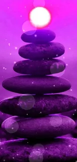 Zen stone stack with purple glow mobile wallpaper.
