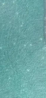 Aerial view of shimmering aqua blue ocean waves meeting sandy shoreline.