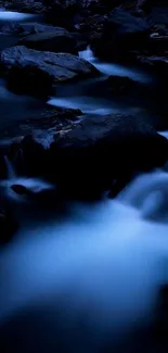 Dark blue stream with flowing water and rocks.