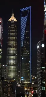 Shanghai skyscrapers glowing under night sky.