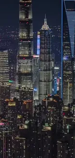 Shanghai skyline with lit skyscrapers at night.