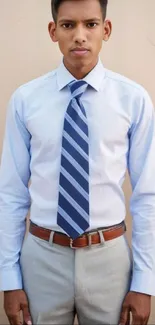 Man in light blue shirt and tie on brown background.