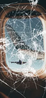 Shattered airplane window with sky view.