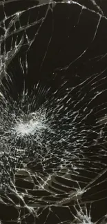 Shattered glass pattern in dark tones on phone wallpaper.