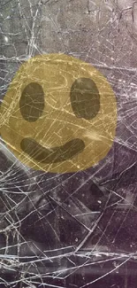 Shattered glass screen with a smiling emoji overlaid for a quirky artistic effect.