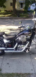 Shiny black motorcycle parked on a street.