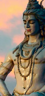 Lord Shiva meditating at sunset in calming wallpaper.