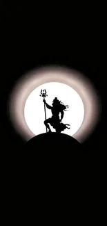 Silhouette of Shiva with trident against a glowing full moon.