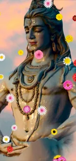 Shiva statue with colorful flowers and sunset backdrop.